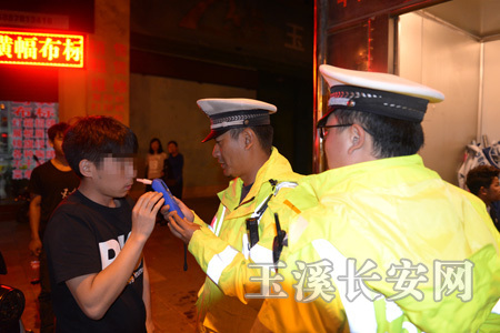 民警在对驾驶员进行酒精呼气测试